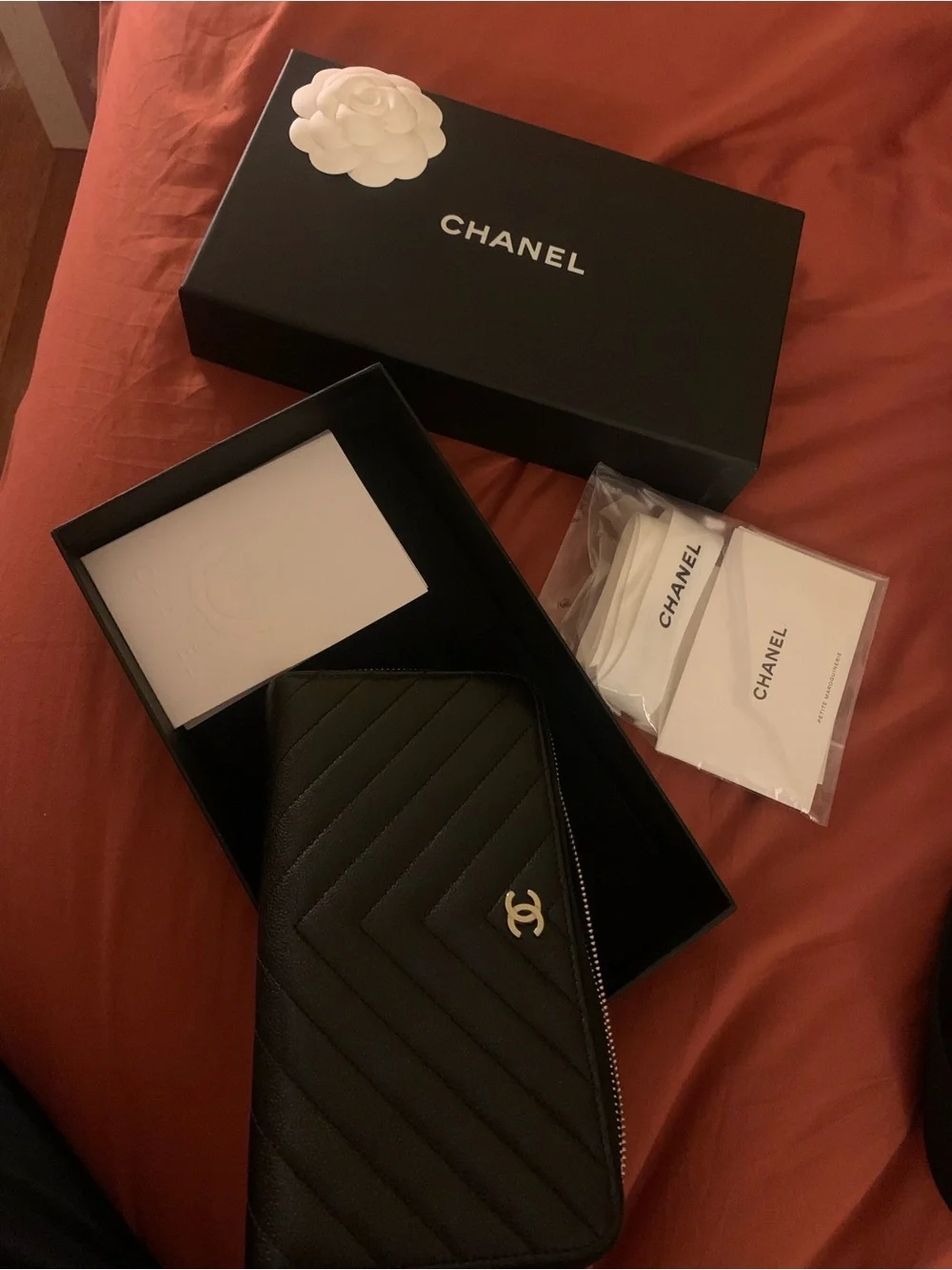 CHANEL Black Chevron Zip Around Wallet with Silver CC Emblem